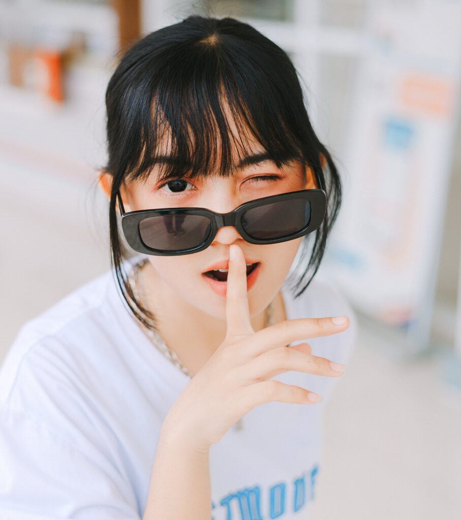 A girl winking wearing a sun-glass